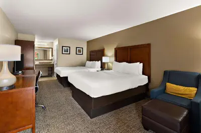 a hotel room with two beds and a chair at Comfort Inn & Suites Sequoia Kings Canyon in Three Rivers