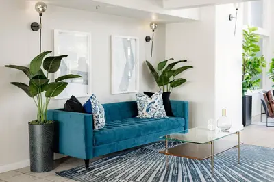 a blue couch in a living room with a table at Quality Inn & Suites Lathrop in Lathrop