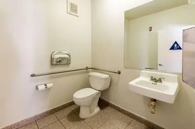 a bathroom with a toilet and a sink at Quality Inn Fresno Near University in Fresno
