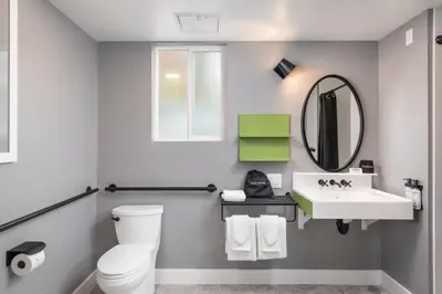 a bathroom with a white toilet and a sink at Hotel Lumberjack - Sonora in Sonora
