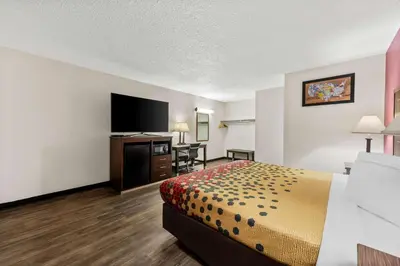 a hotel room with a bed and a flat screen tv at Econo Lodge Fallon Naval Air Station Area in Fallon