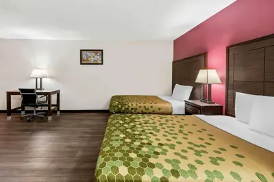 a hotel room with two beds and a desk at Econo Lodge Fallon Naval Air Station Area in Fallon