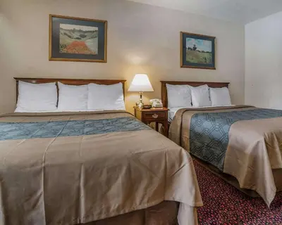 a hotel room with two beds and a lamp at Econo Lodge Near Reno-Sparks Convention Center in Reno
