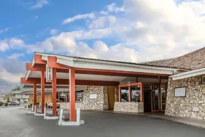a building with red pillars in a parking lot at Econo Lodge Near Reno-Sparks Convention Center in Reno