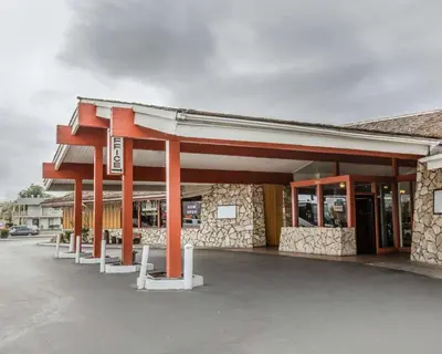 a gas station with orange pillars in a parking lot at Econo Lodge Near Reno-Sparks Convention Center in Reno