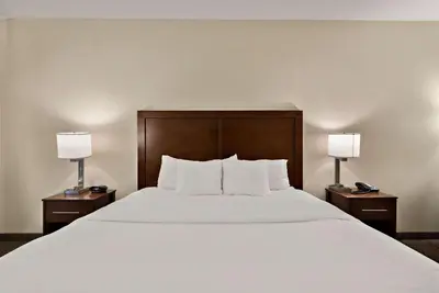 a bed in a hotel room with two lamps at Comfort Inn & Suites Airport Convention Center in Reno