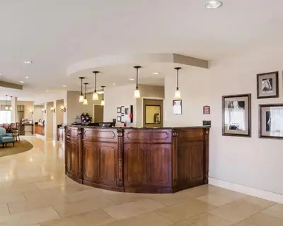a large kitchen with a bar in a living room at Comfort Suites Fernley in Fernley