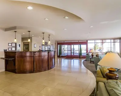 a large living room with a couch and a bar at Comfort Suites Fernley in Fernley
