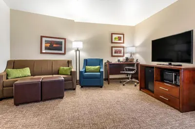 a living room with a couch and a flat screen tv at Comfort Suites Fernley in Fernley