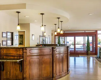 a kitchen with a large wooden bar with pendant lights at Comfort Suites Fernley in Fernley
