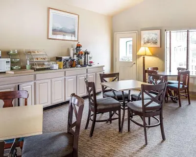 a dining room with a table and some chairs at Quality Inn & Suites Minden in Minden