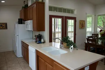 a kitchen with a sink and a white refrigerator at Wonder Valley Ranch Resort in Pine Flat Lake