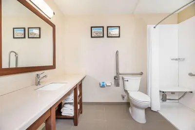 a bathroom with a toilet and a sink and a mirror at Comfort Inn Tonopah in Tonopah
