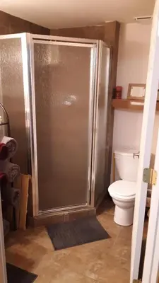 a bathroom with a shower and a toilet at Winterfell Inn - No Xtra Fees, Dogs OK, King & Queen Suites in Arnold