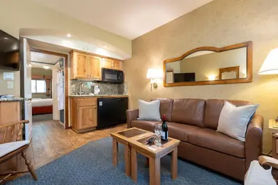 a living room with a couch and a table at Olympic Village Inn Olympic Valley in Olympic Valley