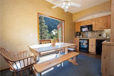 a kitchen with a table and chairs and a window at Olympic Village Inn Olympic Valley in Olympic Valley