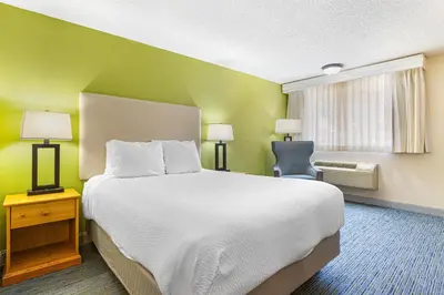 a hotel room with a large bed and a chair at Best Western Hi-Desert Inn in Tonopah