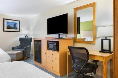 a hotel room with a desk and a television at Best Western Hi-Desert Inn in Tonopah