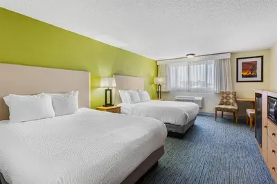 a hotel room with two beds and a television at Best Western Hi-Desert Inn in Tonopah