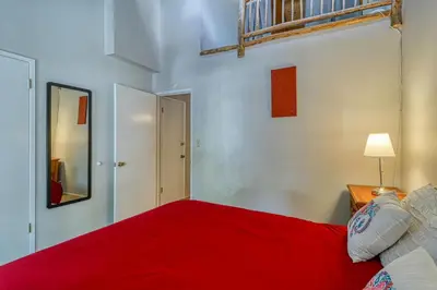 a bedroom with a red bed and a mirror at 2 Bed 2 Bath Apartment in Carnelian Bay in Carnelian Bay