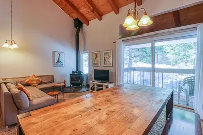 a living room with a wooden table and a couch at 2 Bed 2 Bath Apartment in Carnelian Bay in Carnelian Bay