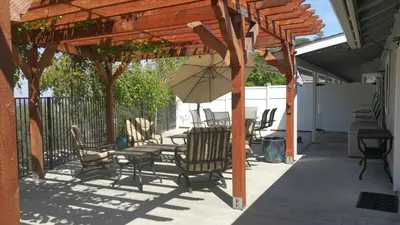 a patio with a table and chairs and an umbrella at Yosemite Foothill Retreat - Private Guest Suite #2 in Coarsegold