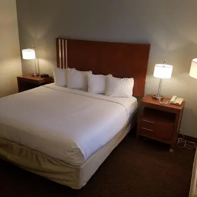 a hotel room with a large bed with two night stands at SureStay Hotel by Best Western Hollister in Hollister