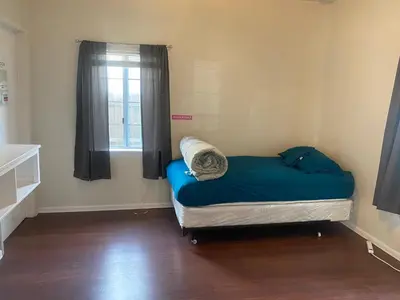 a small bed in a room with a window at WHOLE Family - WholeVille in Sacramento
