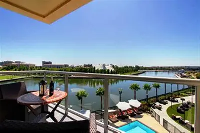 a balcony with a view of a pool and a resort at University Plaza Waterfront Hotel in Stockton