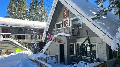 a house with snow on the porch at Cinnamon Bear Inn in Mammoth Lakes