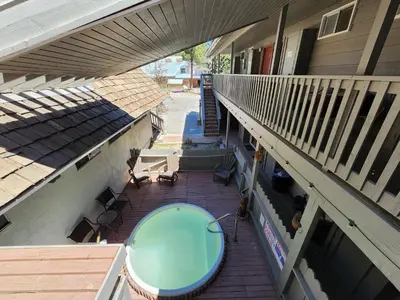 an overhead view of a patio with a table on a balcony at Cinnamon Bear Inn in Mammoth Lakes