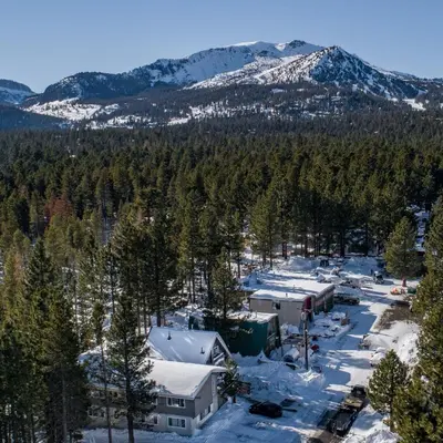 an aerial view of a resort in the snow with a mountain at Cinnamon Bear Inn in Mammoth Lakes