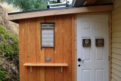 a shed with a door and a sign on it at The Quail's Nest in Three Rivers