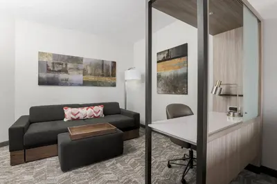 a living room with a couch and a table at Hotel Vista Sierra in Auburn