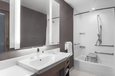 a bathroom with a sink and a tub and a mirror at Hotel Vista Sierra in Auburn