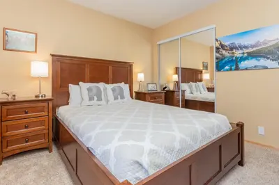 a bedroom with a large bed and a large mirror at Snowcreek IV 588 in Mammoth Lakes