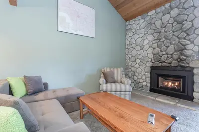 a living room with a couch and a fireplace at Snowcreek IV 588 in Mammoth Lakes