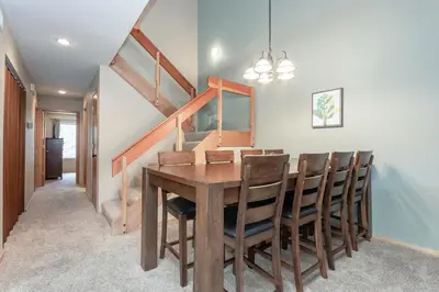 a dining room with a wooden table and chairs at Snowcreek IV 588 in Mammoth Lakes