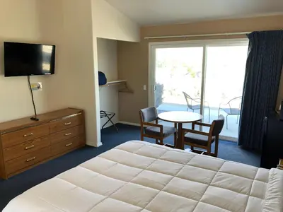 a hotel room with a bed and a table with chairs at Meadowcliff Lodge Coleville in Coleville