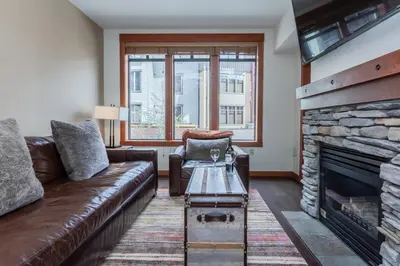 a living room with a couch and a fireplace at Village 3211 in Mammoth Lakes
