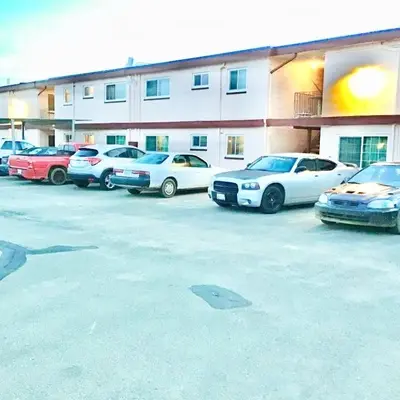 a group of cars parked in front of a building at Royal Lodge in Coalinga