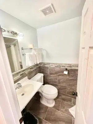 a bathroom with a toilet and a sink at Royal Lodge in Coalinga