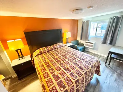 a hotel room with a bed and a window at Royal Lodge in Coalinga