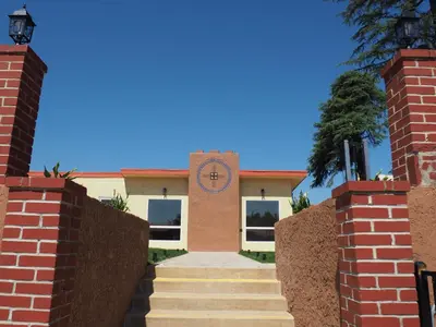 a building with a clock on the front of it at The Greens Hotel on Stockton in Sacramento