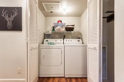 a small laundry room with a washer and dryer at Silver Bear #19 Condo in Mammoth Lakes