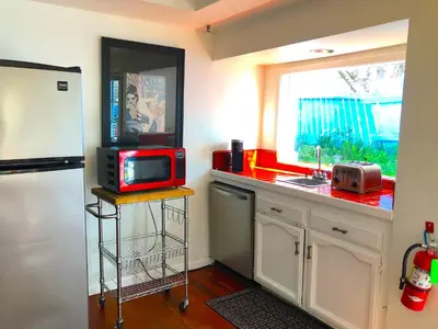 a kitchen with a counter with a microwave and a refrigerator at Rio Sierra Riverhouse in Three Rivers