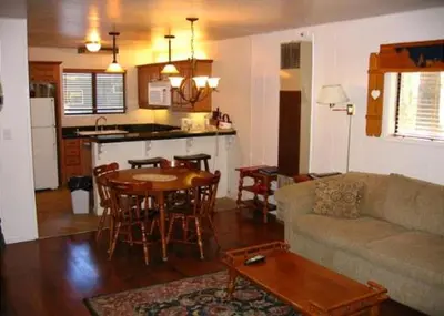 a living room with a couch and a table and a kitchen at Birch Creek #8 - 2BR/1.5BA in June Lake