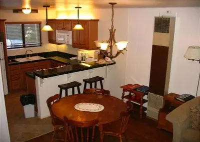a kitchen with a table and chairs and a kitchen with a counter at Birch Creek #8 - 2BR/1.5BA in June Lake