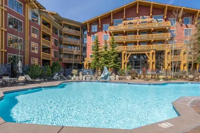 a large swimming pool in front of a building at Village # 3310 - Lincoln House in Mammoth Lakes