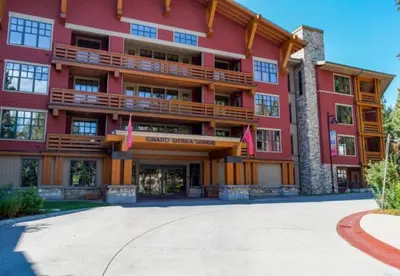 a large red building with flags in front of it at Village # 3310 - Lincoln House in Mammoth Lakes